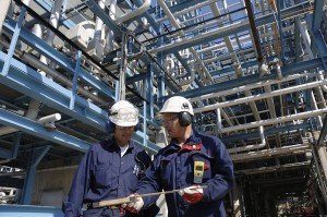 two engineers inside oil refinery